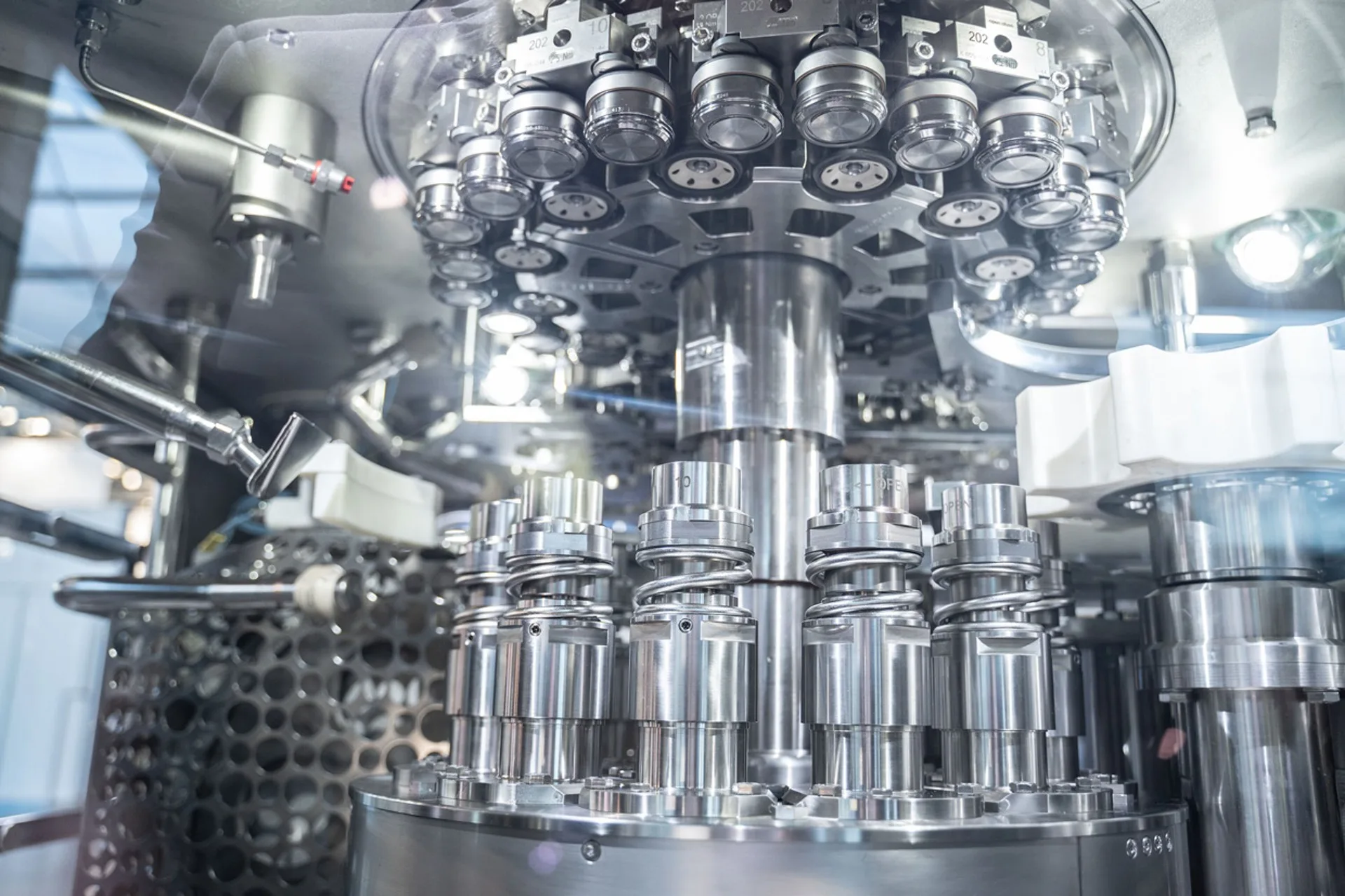 Stainless steel can seaming heads and rotary container handling components