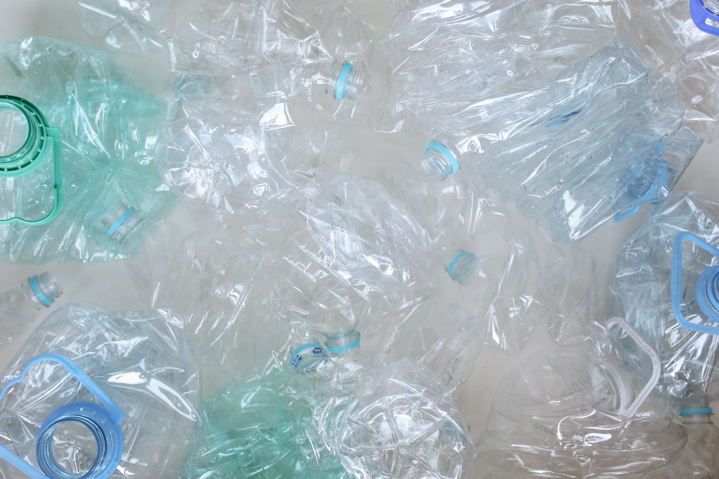 Blue and green plastic bottles collected for recycling